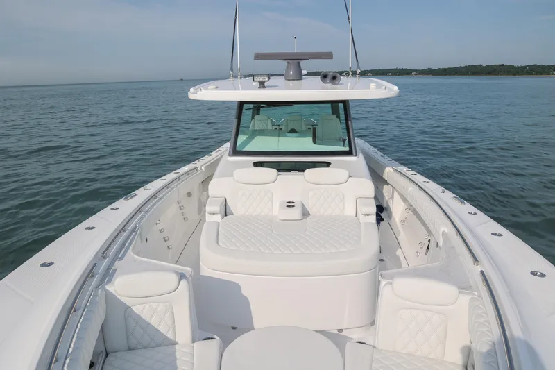 Slide: The Image of Luxurious 2027 HCB 48 Campeon boat with elegant seating on calm waters. - 12