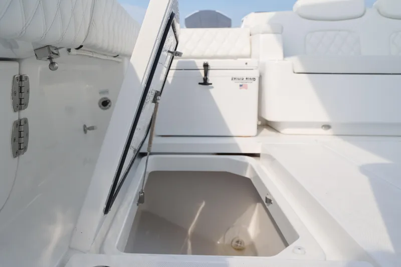 Slide: The Image of Open storage compartment on 2027 HCB 48 Campeon boat, featuring sleek white interior design. - 14
