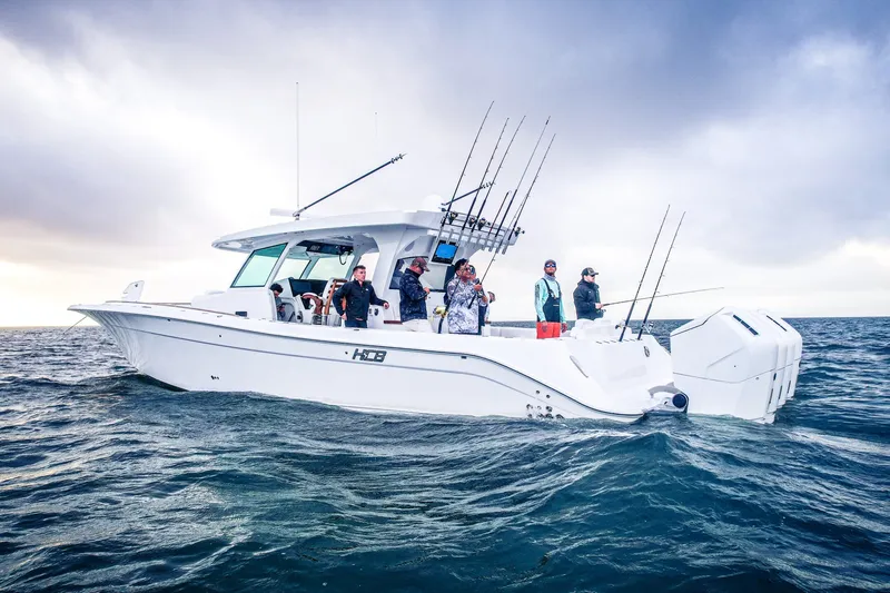 Slide: The Image of 2027 HCB 48 Campeon boat with anglers fishing on open water under cloudy skies. - 3