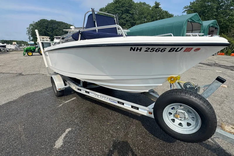 The Image of 2020 Edgewater 170CC boat on trailer, parked outdoors with trees in background. - 0