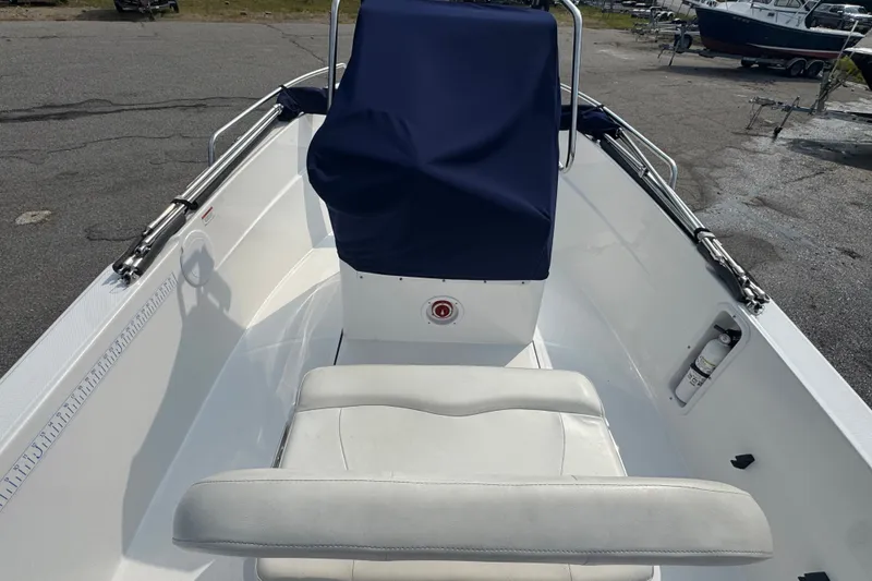 Slide: The Image of 2020 Edgewater 170CC boat interior with blue console cover and white seating. - 6