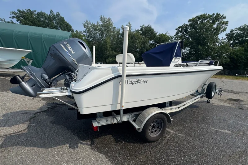 Slide: The Image of 2020 Edgewater 170CC boat on trailer with Yamaha outboard motor, parked outdoors. - 1