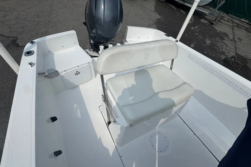 Slide: The Image of 2020 Edgewater 170CC boat interior with white seating and outboard motor. - 2