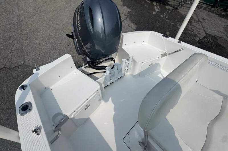Slide: The Image of 2020 Edgewater 170CC boat interior with Yamaha outboard motor, white seating, and storage compartments. - 10