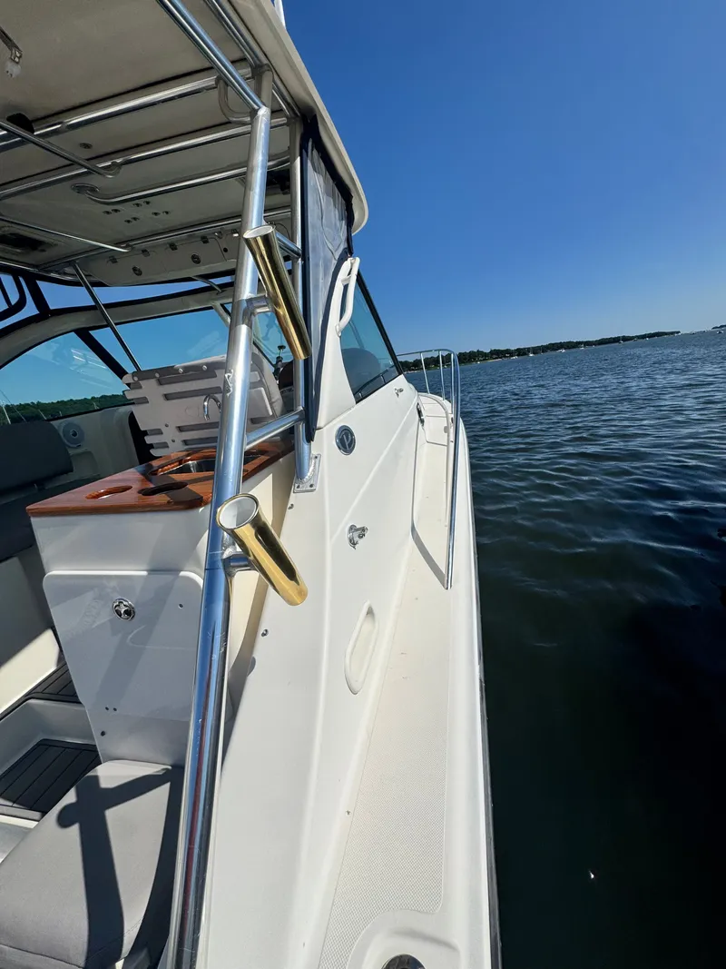 Slide: The Image of A 2006 Pursuit 3370 Offshore on the water. View of the deck and railing. - 18