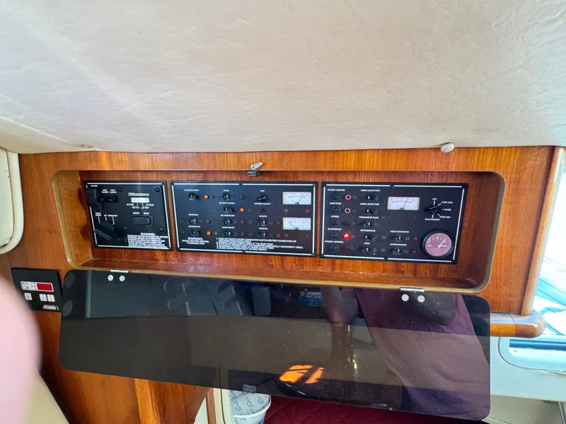 Slide: The Image of The image shows the dashboard of a 2006 Pursuit 3370 Offshore with various switches and gauges. - 20