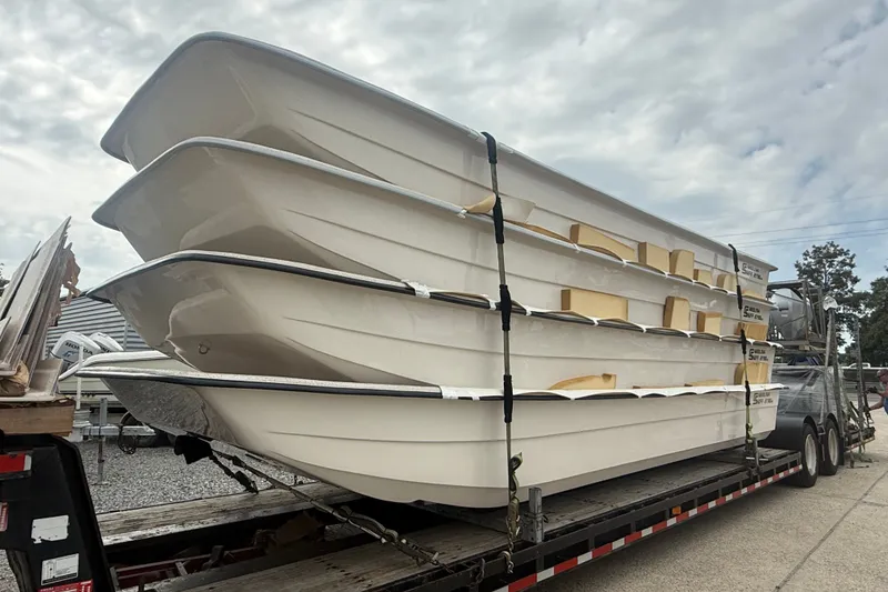 The Image of Stacked 2027 Carolina Skiff 2790 boats on trailer under cloudy sky. - 0
