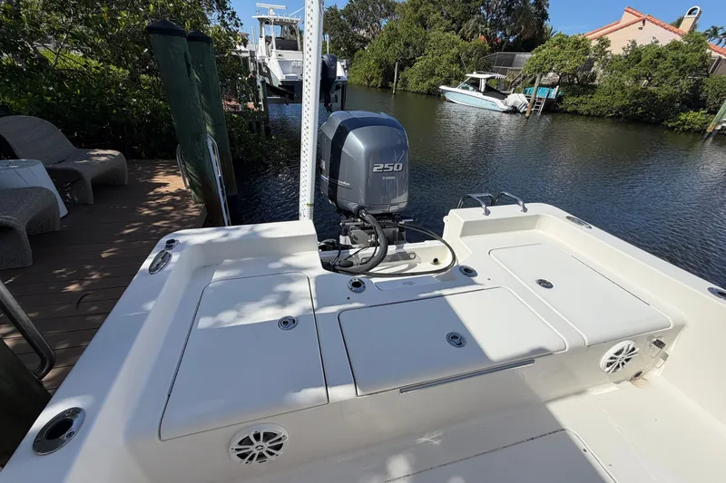 Slide: The Image of 2015 Ranger boat with Yamaha 250 engine docked by a serene waterfront. - 14