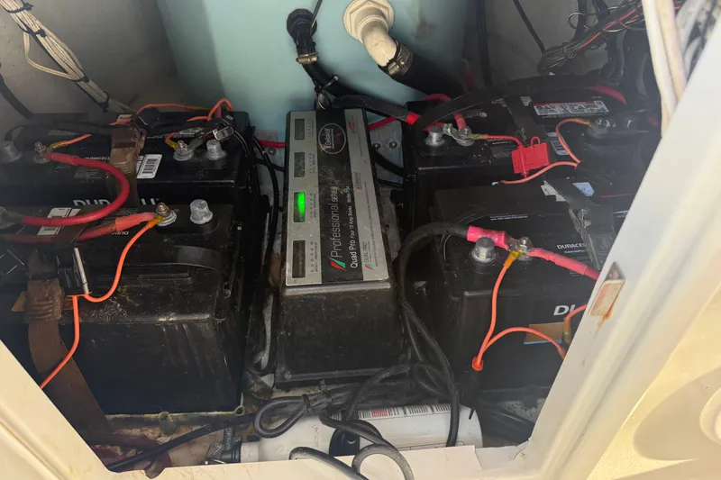 Slide: The Image of Battery compartment with multiple batteries and a charger in a 2015 Ranger vehicle. - 20
