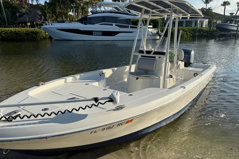 Slide: The Image of 2015 Ranger boat docked in sunny marina with luxury yacht in background. - 3