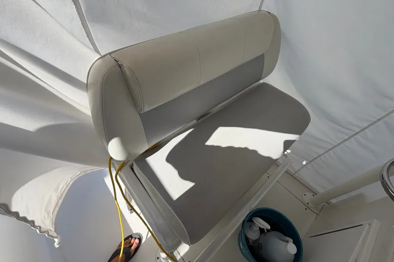 Slide: The Image of Boat seat with white upholstery, yellow cord, and bucket on a Ranger model, 2015. - 9