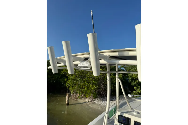 Slide: The Image of Ranger 2015 boat with rod holders and canopy, set against a clear blue sky. - 23