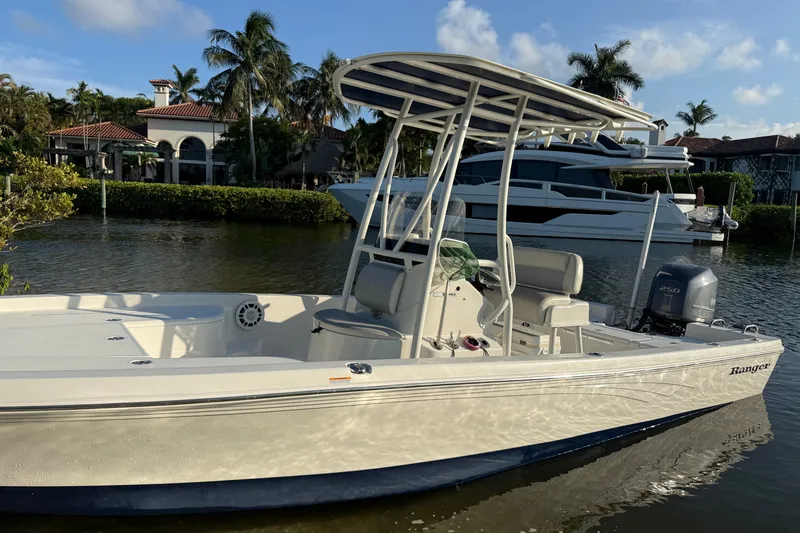 Slide: The Image of 2015 Ranger boat docked by waterfront homes, featuring a sleek design and powerful engine. - 4