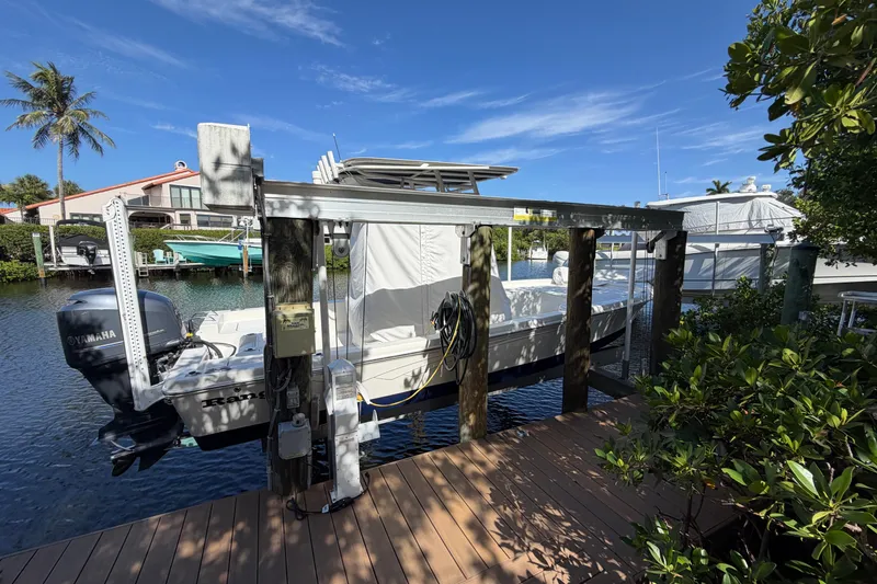 Slide: The Image of Boat docked on a sunny day, featuring a 2015 Ranger model with Yamaha engine. - 17