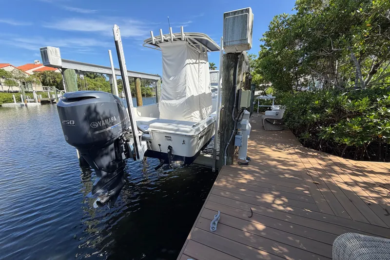 Slide: The Image of Boat with Yamaha 250 engine on dock, surrounded by water and greenery, 2015 Ranger model. - 16
