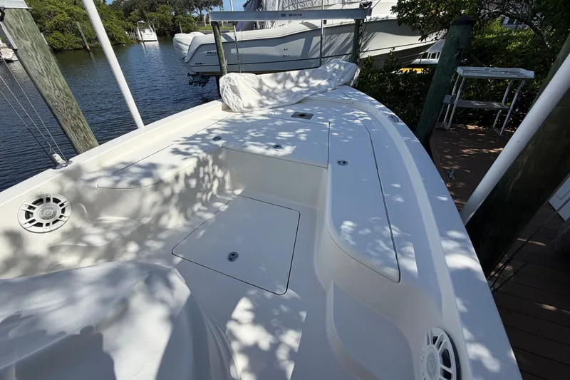 Slide: The Image of 2015 Ranger boat docked by a serene waterfront, surrounded by lush greenery. - 11
