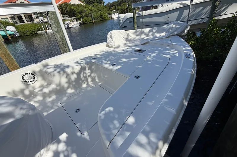 Slide: The Image of 2015 Ranger boat docked by waterfront, featuring spacious deck and sleek design. - 7