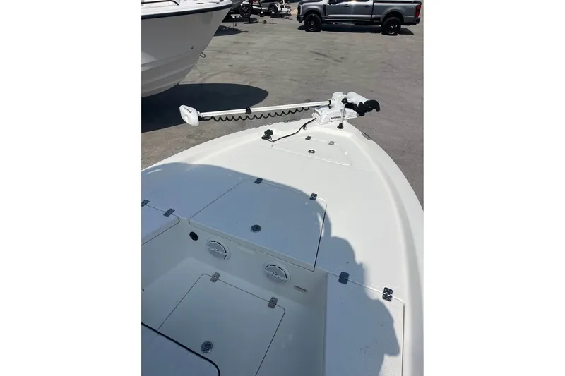 Slide: The Image of 2016 Mako 19 CPX boat deck with trolling motor, parked outdoors. - 8