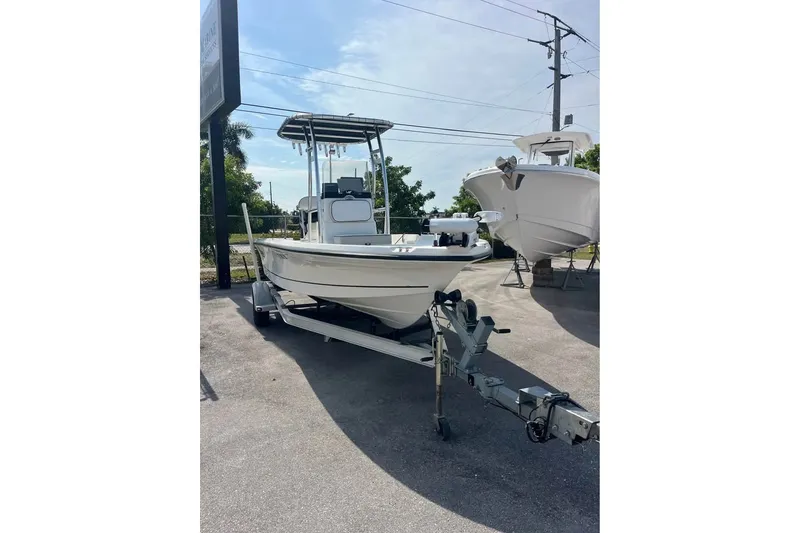 The Image of 2016 Mako 19 CPX boat on trailer in outdoor setting. - 1