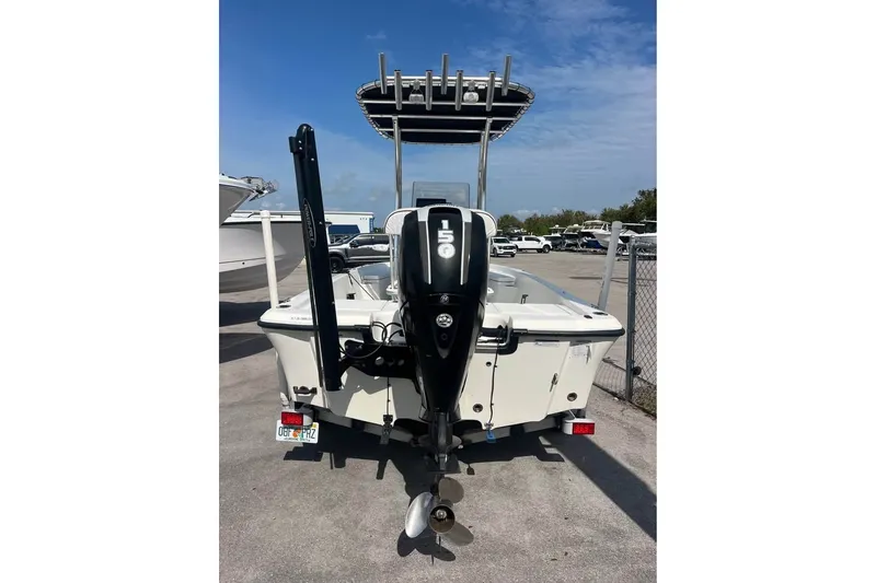 Slide: The Image of 2016 Mako 19 CPX boat with 150 HP engine, parked on a trailer. - 10