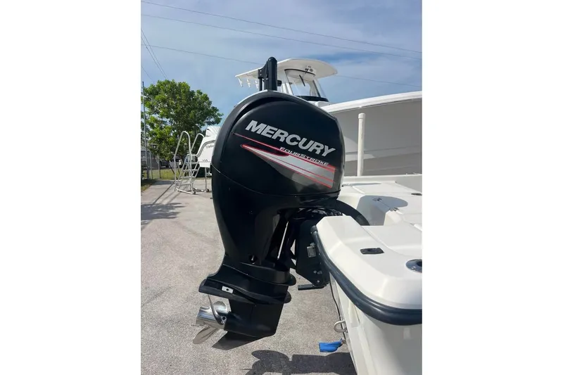 Slide: The Image of 2016 Mako 19 CPX boat with Mercury outboard motor in a sunny outdoor setting. - 9