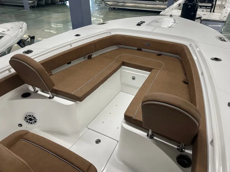 Slide: The Image of The image shows the cockpit of a 2027 Sea Hunt Ultra 265 SE with brown upholstery. - 18