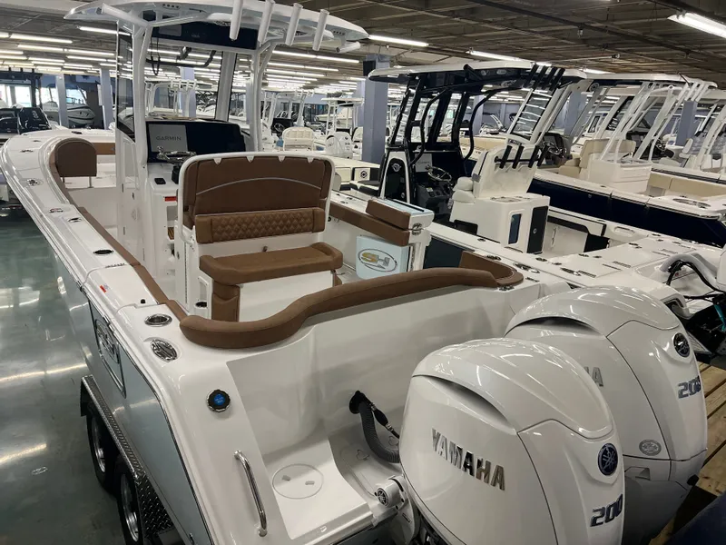 Slide: The Image of The image shows a 2027 Sea Hunt Ultra 265 SE boat in a showroom. - 8