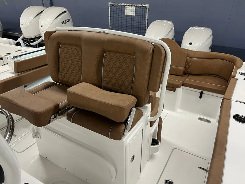 Slide: The Image of The 2027 Sea Hunt Ultra 265 SE features luxurious brown upholstery and modern seating in the cockpit. - 16
