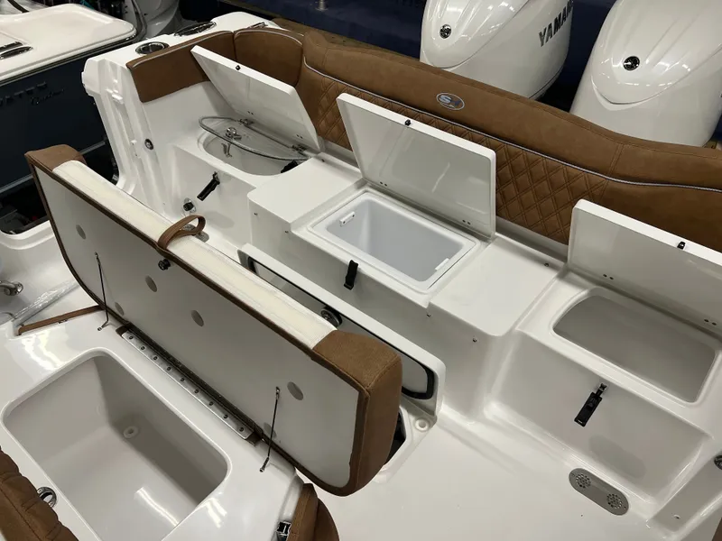 Slide: The Image of The image shows the cockpit of a Sea Hunt Ultra 265 SE boat with multiple storage compartments. - 10