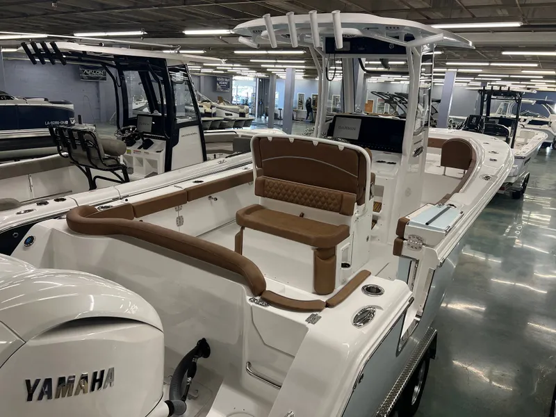 Slide: The Image of The image shows a 2027 Sea Hunt Ultra 265 SE boat in a showroom. - 9