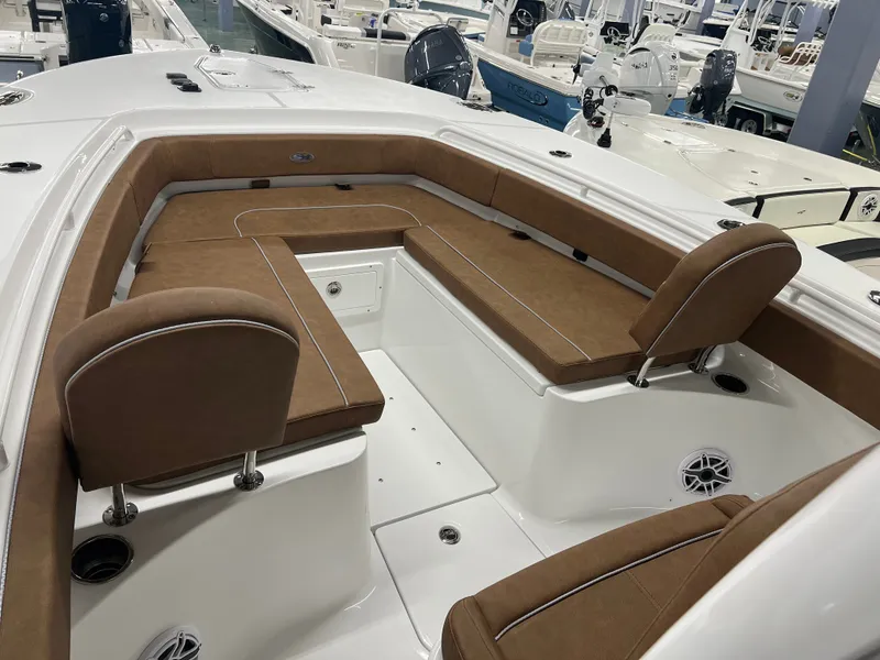 Slide: The Image of The image shows the bow area of a 2027 Sea Hunt Ultra 265 SE boat with brown upholstery. - 17