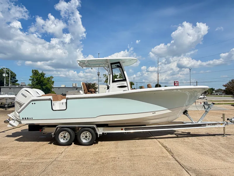 Slide: The Image of A 2027 Sea Hunt Ultra 265 SE boat on a trailer under a blue sky. - 4
