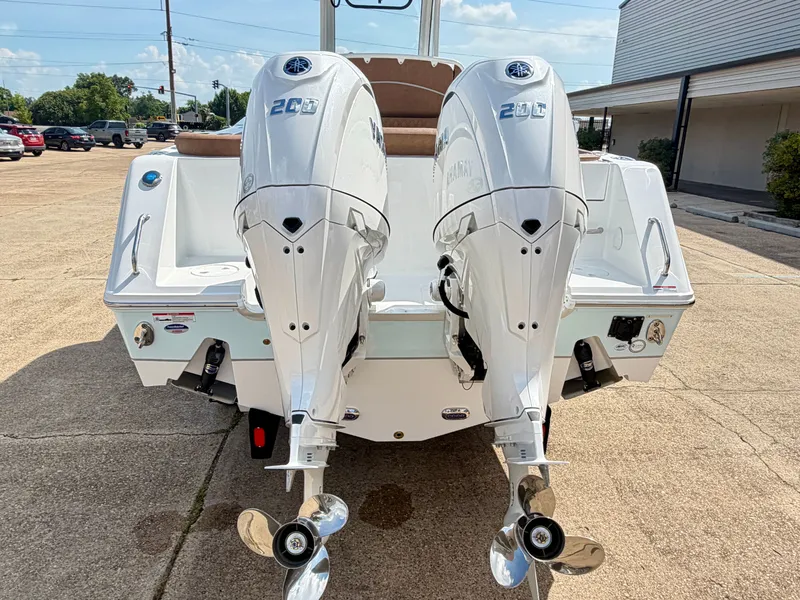 Slide: The Image of The image shows the rear of a Sea Hunt Ultra 265 SE boat with two outboard engines. - 7