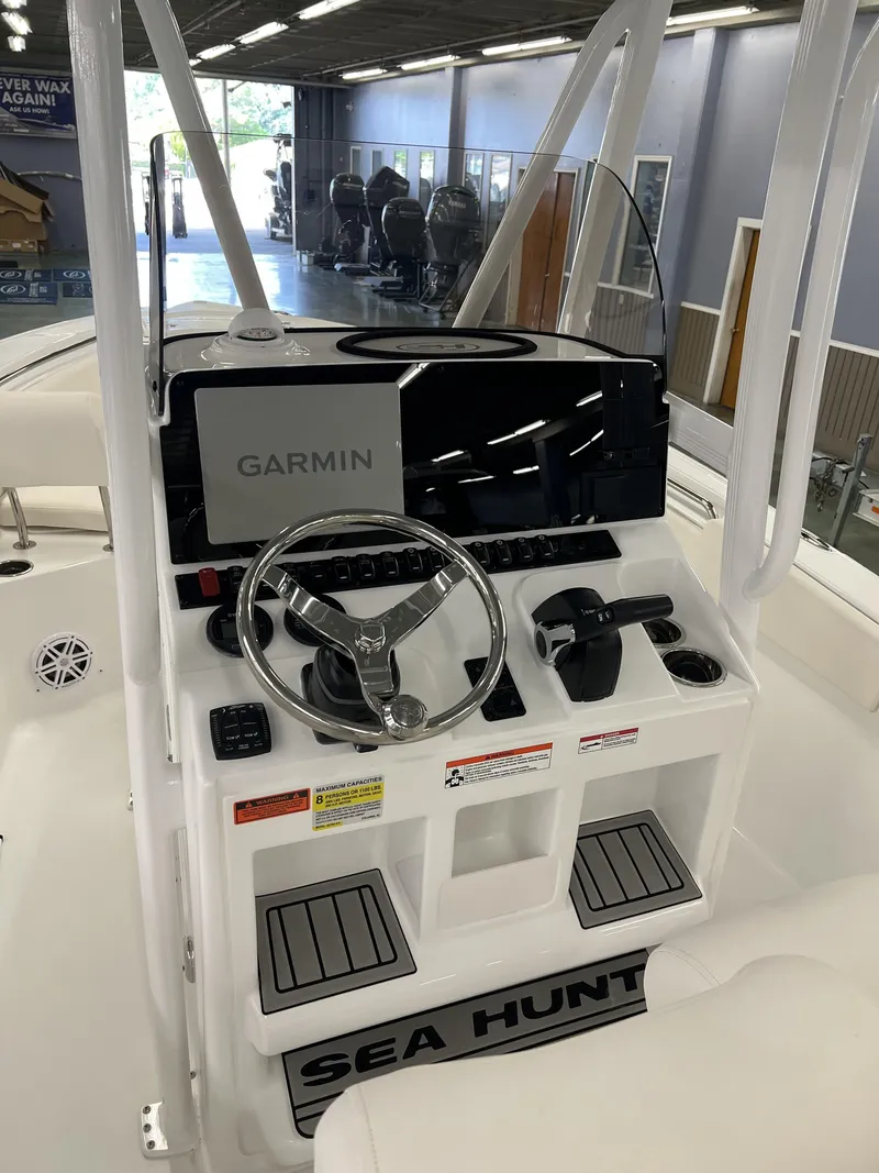 Slide: The Image of The image shows the helm of a Sea Hunt Ultra 219 boat with a Garmin navigation system. - 10