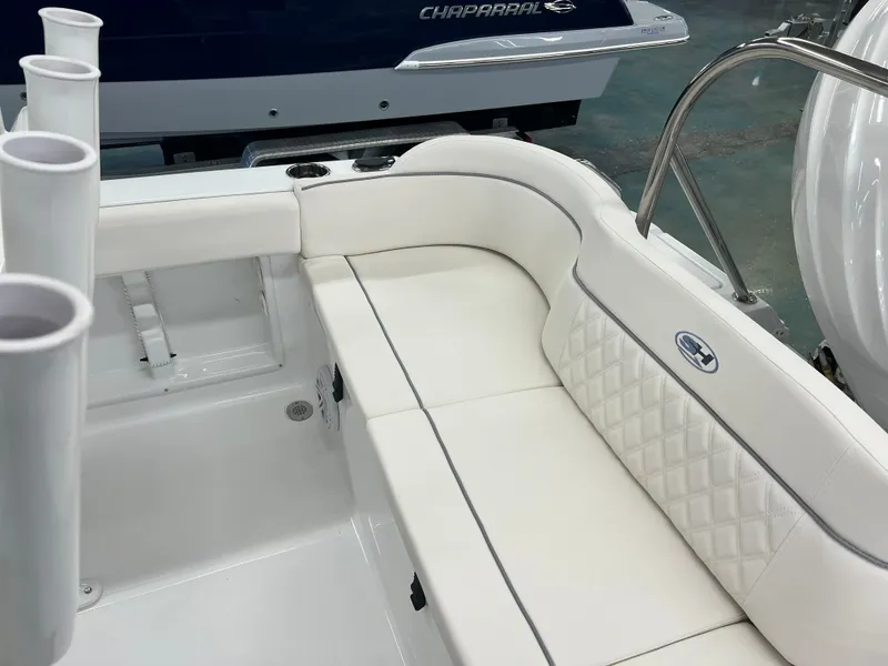 Slide: The Image of The image shows the white upholstery of a bench seat on a Sea Hunt Ultra 219 boat. - 9