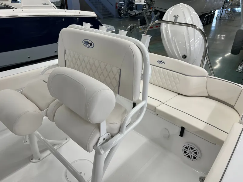 Slide: The Image of The image shows the interior of a 2027 Sea Hunt Ultra 219 boat with white upholstery. - 7