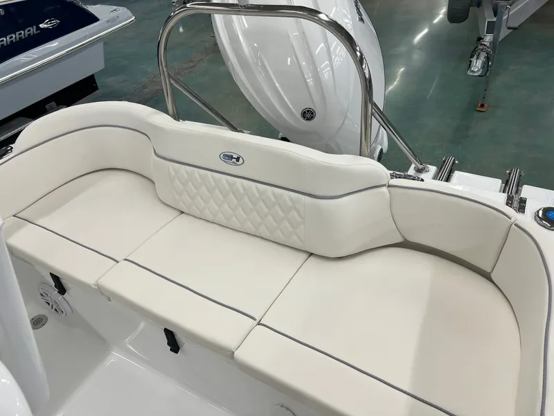 Slide: The Image of The image shows the white upholstery of a bench seat on a Sea Hunt Ultra 219 boat. - 8