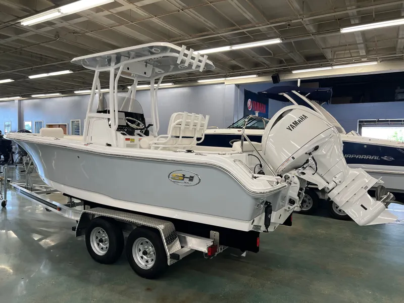 Slide: The Image of A 2027 Sea Hunt Ultra 219 boat on a trailer in a showroom. - 6