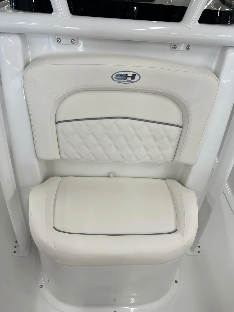 Slide: The Image of A white seat with quilted pattern and Sea Hunt logo on a boat console. - 12