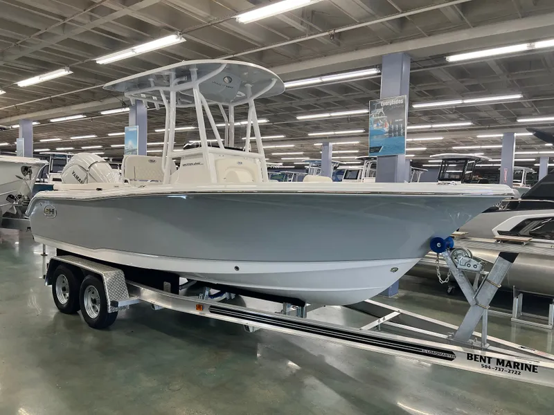 Slide: The Image of A 2027 Sea Hunt Ultra 219 boat on a trailer in a showroom. - 4