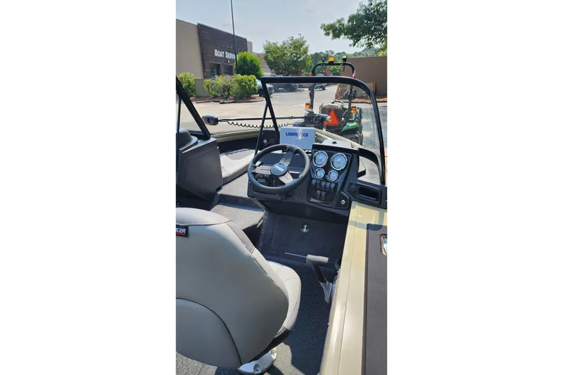 Slide: The Image of 2027 Tracker Targa V-18 Combo boat interior with steering wheel and dashboard controls. - 4