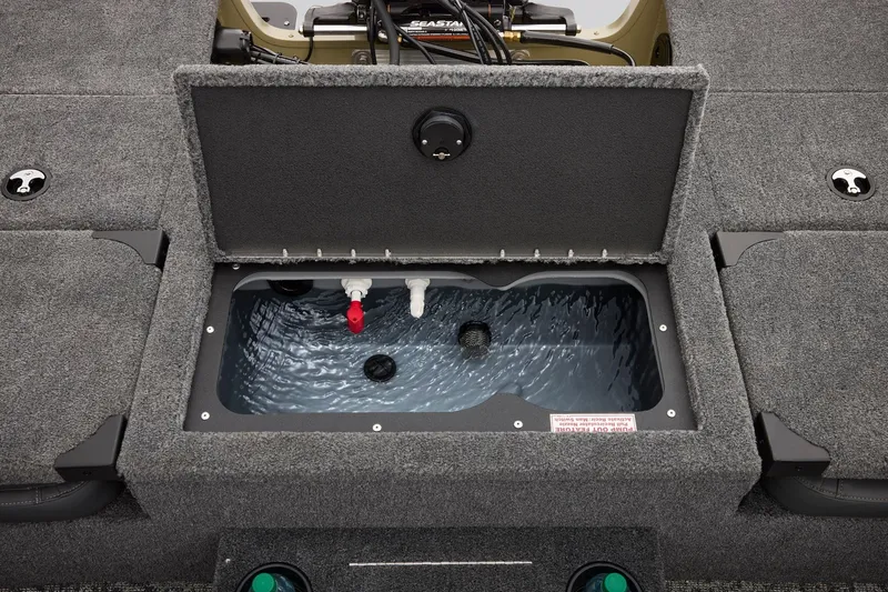 Slide: The Image of Open livewell compartment on 2027 Tracker Targa V-18 Combo boat, showing interior water. - 6
