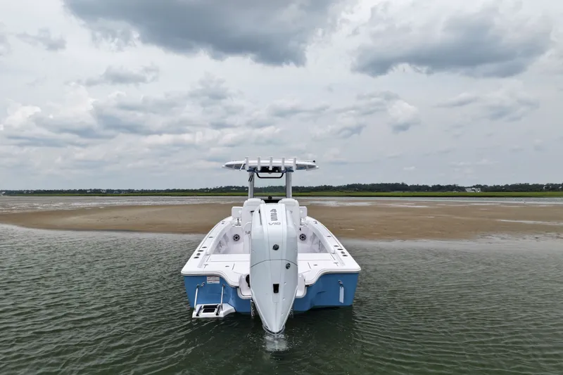 Slide: The Image of 2027 Sportsman Masters 267 Bay Boat in shallow water, cloudy sky backdrop. - 3