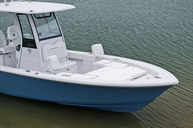 Slide: The Image of 2027 Sportsman Masters 267 Bay Boat on calm water, showcasing sleek design and seating. - 7