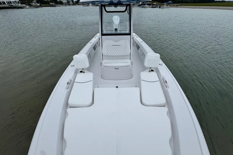 Slide: The Image of 2027 Sportsman Masters 267 Bay Boat on calm water, showcasing spacious seating and sleek design. - 10