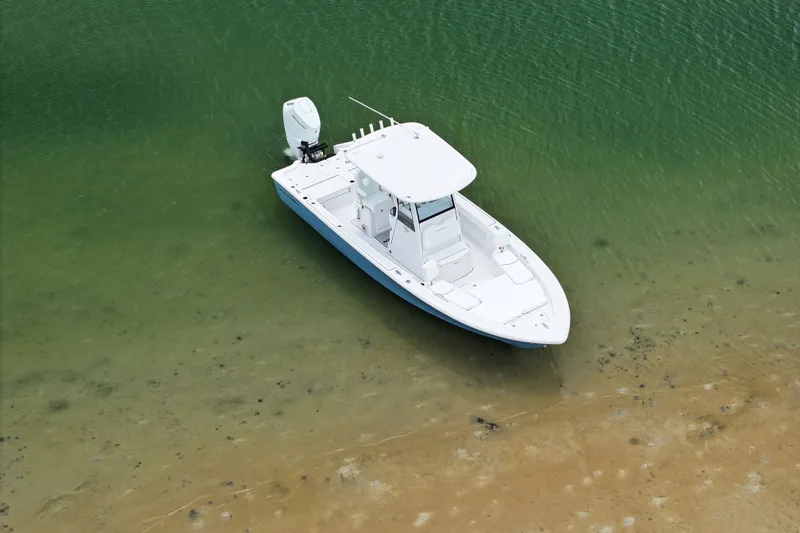 Slide: The Image of 2027 Sportsman Masters 267 Bay Boat anchored in shallow, clear water. - 8