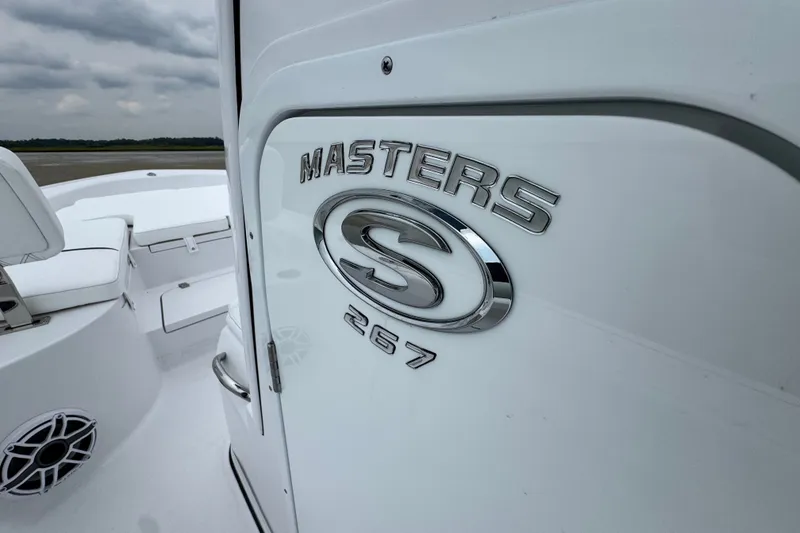 Slide: The Image of 2027 Sportsman Masters 267 Bay Boat, sleek white design with logo detail. - 14