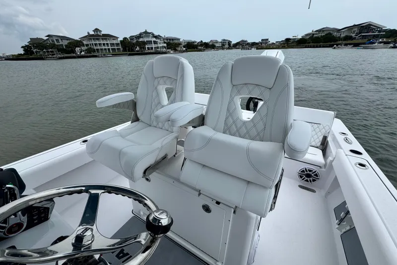 Slide: The Image of Luxurious seating on 2027 Sportsman Masters 267 Bay Boat, with waterfront view. - 16