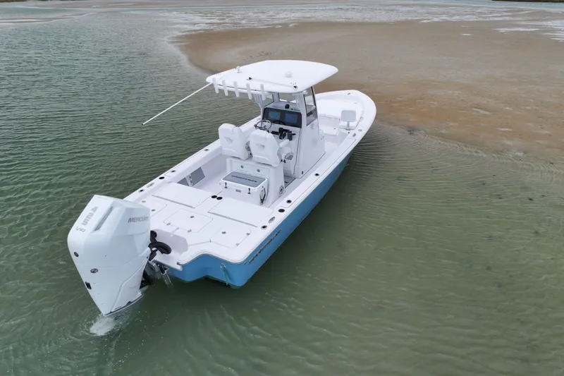 Slide: The Image of 2027 Sportsman Masters 267 Bay Boat in shallow water, showcasing sleek design and powerful engine. - 4