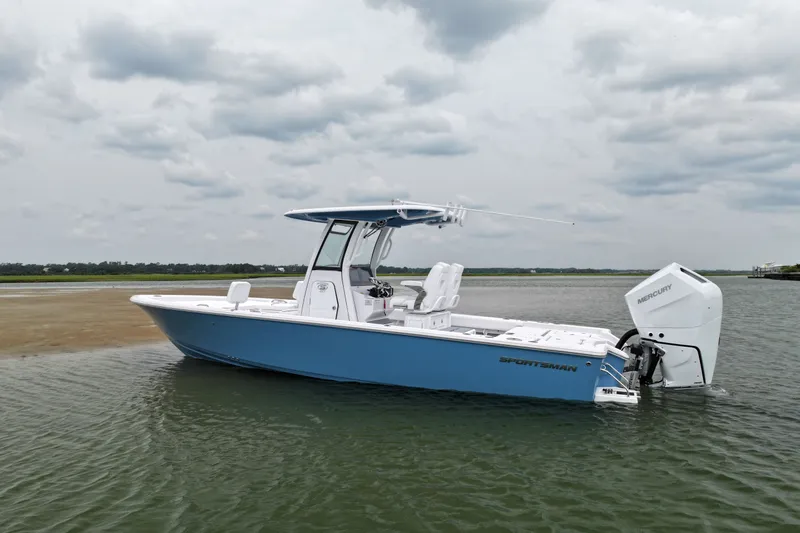 Slide: The Image of 2027 Sportsman Masters 267 Bay Boat on calm water under cloudy sky. - 2